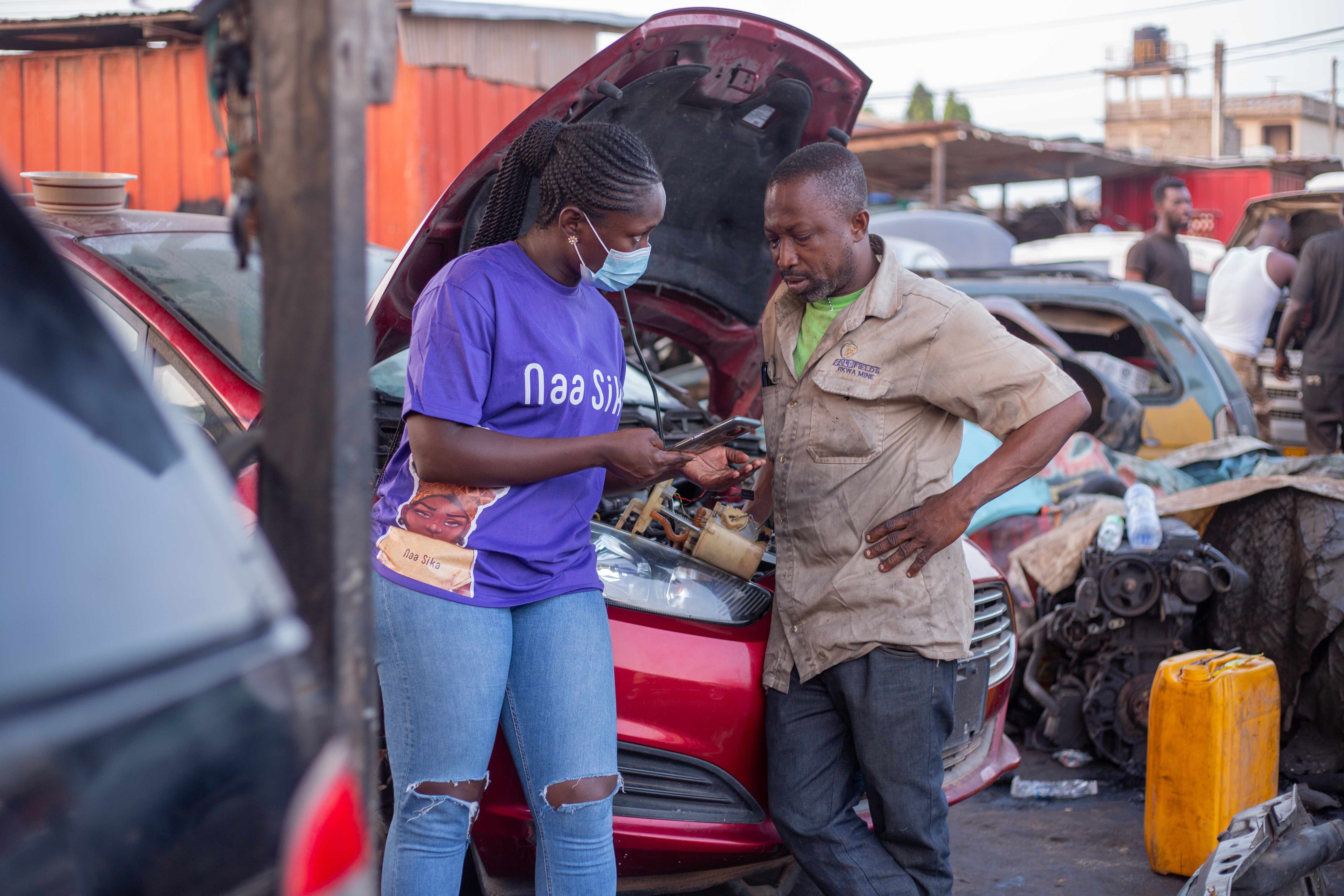 Auto repair shop worker learning about Naa Sika